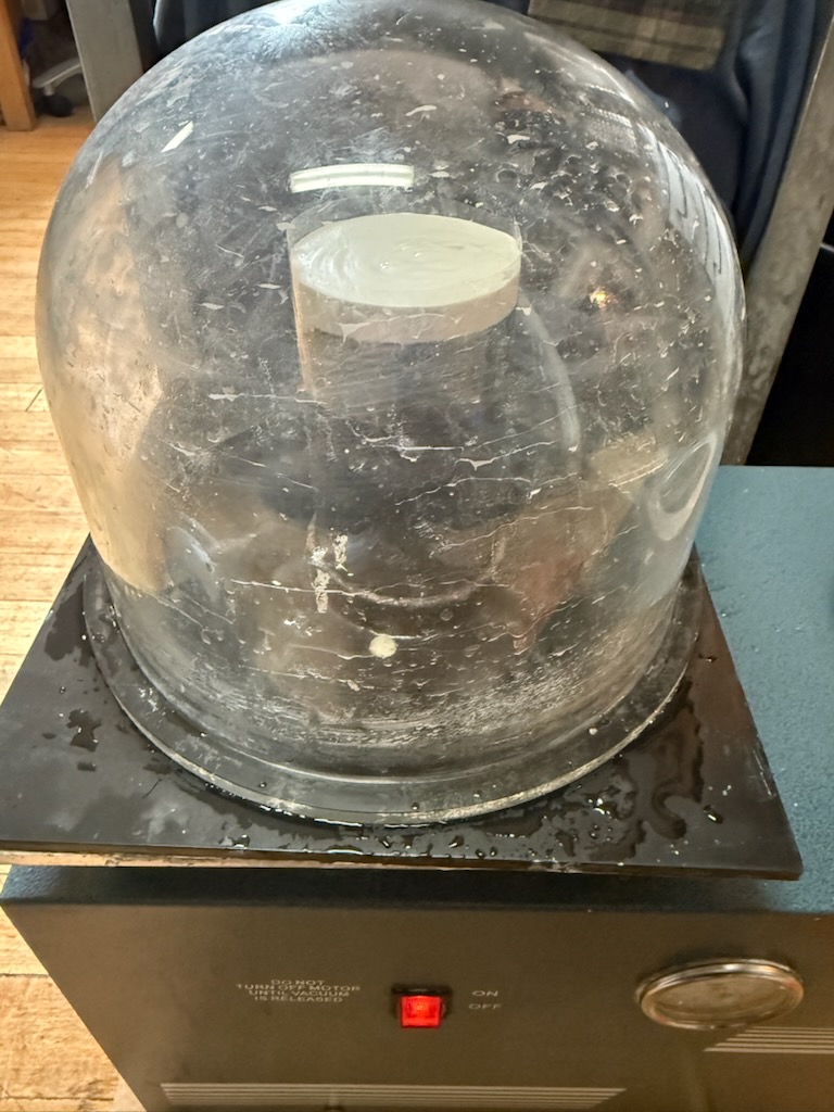 Vacuuming bubbles out of the plaster